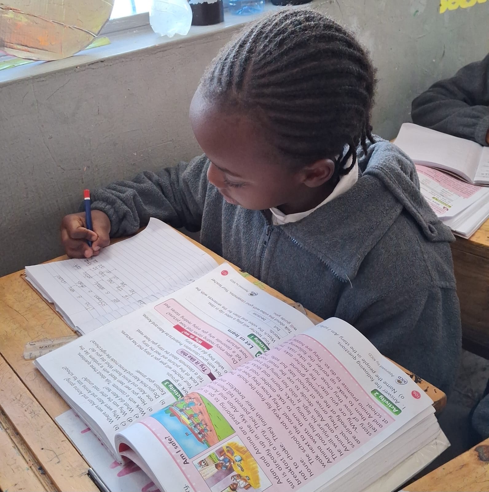 A Bridgerose Jewels Academy pupil writing in class